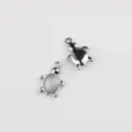 Close-up detail of silver alloy turtle pendant charms with stone inlay for DIY jewelry making. - Silver Blue