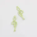Close-up of light green painted alloy bow double-hang connector charms for DIY jewelry making. - Fruit Green