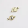 Detailed close-up view of gold alloy arrow through heart crystal DIY jewelry charm pendants. - Gold Base White
