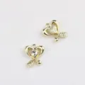 Detail view of gold alloy heart arrow pendants, perfect for DIY jewelry charm making accessories. - Gold Base White Diamond