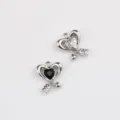 Close-up detail of silver alloy heart arrow charms, perfect for DIY jewelry and necklace making. - Silver Base Black Rhinestone