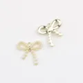 Close-up detail of gold alloy bow charms with faux pearls, ideal for DIY jewelry making. - Bowknot (Artificial Pearl) / 20 Pieces Set / Gold