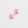Close-up view of cute pink alloy balloon dog charms, perfect for DIY jewelry making details. - Rose Red
