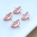 Close-up of gold-plated pink crystal semi-circular double loop charms for DIY jewelry making. - Pink