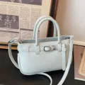 Lichtblauwe mini handtas met handvatten en schouderband, stijlvolle PU lederen tas voor dames. - Blauw