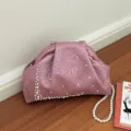 Stylish pink metallic textured clutch bag featuring elegant pearl decorations and shoulder strap. - Pink