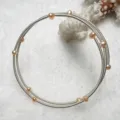 Detail view of multi-layer natural freshwater pearl memory wire bracelet with shiny metallic coils - Pink Silver Tone