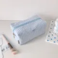 Blue white striped fabric pencil case detail view with cute bow embroidery and zipper. - Blue Striped