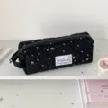 Detailed view of black canvas pencil case with star pattern, large capacity stationery storage bag. - Black