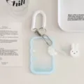 Detailed view of clear wavy card holder keychain with spring lanyard and cute angel wing charm. - Blue