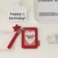 Close-up detail of the red PU photocard holder with star pendant, lovely design and neat stitching. - Red