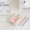 Detailed close-up of quilted fabric card holder with ruffled edge and clear ID window display. - White