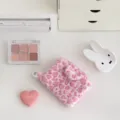Pink fuzzy leopard coin purse detail, cute plush earphone bag and card holder flat lay view. - Pink Leopard Bag