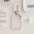 Detailed close-up of a transparent acrylic card holder featuring white spring lanyard and wing pendant. - Purple