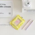 Detailed view of the yellow fabric ruffled photocard holder pendant, cute Korean style card sleeve. - Yellow