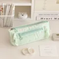 Green canvas pencil case featuring cute pink stars, ruffles and star-shaped zipper pulls. - Green