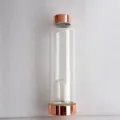 Detail view of a clear glass water bottle featuring rose gold caps and an internal crystal chamber. - Rose Gold Small Opening (Without Crystal Stone) / 550ml