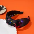 Detailed view of Halloween wide knotted headband with colorful star and moon patterns - Purple Red Starry Style / Black Multicolor