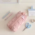 Pink quilted pencil case detail showing the oversized zipper and soft fabric texture. - Pink