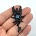 Detail shot of retro black angel wing key pendant with blue moonstone, intricate gothic design. - Black