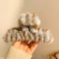 Fluffy brown plush hair claw clip featuring a stylish striped pattern for thick hair styling. - Blue Stripe