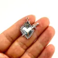 Detail shot of a vintage gothic antique silver alloy sacred heart dagger pendant DIY accessory. - Red Style Sword Heart