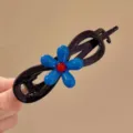 Black twisted hair clip featuring a bright blue flower with red center, stylish detail view. - Blue Flower 8-Clip