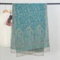 Detailed view of a vintage blue paisley jacquard scarf with elegant tassels on a rack - Paisley Jacquard Style with Tassels / 70x200cm / Lake Blue