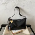 Chic black PU leather shoulder bag with floral charm and spacious interior for commuting. - With Charm / Black