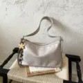 Chic grey shoulder bag for women, stylish hobo crossbody bag with charming beaded pendant. - With Charm / Off White