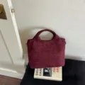 Burgundy woven leather tote bag detail showcasing intricate texture and chic casual style - Burgundy