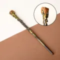 Vintage fantasy magic wand with natural red crystal tip and golden vine detail - Tiger's Eye