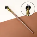 Vintage magic wand with natural black crystal tip and golden lava texture detail. - Obsidian