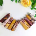 Assorted natural hexagonal crystal points in various earthy tones and patterns - Egg Yolk Stone Pillar / 8-9cm