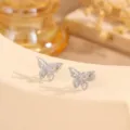 Close-up shot of sparkling stainless steel butterfly stud earrings with textured finish. - Butterfly Gauze Pressed Style