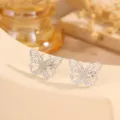 Detailed shot of exquisite stainless steel butterfly stud earrings with delicate pave texture. - Hollow Butterfly Gauze Pressed Style