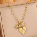 Gold titanium steel evil eye heart necklace detail, featuring paperclip chain and charms. - Gold Eye Heart Necklace