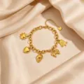 Gold plated stainless steel multi-charm bracelet featuring sun, heart, shell, and bow pendants. - Style 7 Gold Conch Multi Pendant Bracelet
