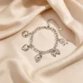 Silver multi-charm stainless steel bracelet with bow, heart, sun, and shell pendants. - Style 8 Steel Color Conch Multi Pendant Bracelet