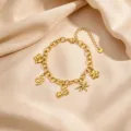 Gold multi-charm bracelet detail featuring butterfly snake heart and flower pendants on satin. - Style 5 Gold Cherry Multi Pendant Bracelet