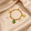Detailed shot of retro gold stainless steel charm bracelet with sun, moon, pearl and bow. - Style 3 Sun Multi Pendant Bracelet