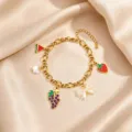 Gold stainless steel fruit charm bracelet with sweet enamel watermelon and strawberry pendants. - Grape Pendant Style / Gold