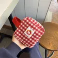 Red plaid plush cosmetic bag with cute apple character design, perfect for portable storage. - Red Plaid Apple Storage Bag