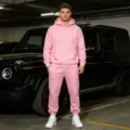 Men pink fleece hooded sweatshirt and jogger set scene detail shot, casual wear lifestyle. - Pink