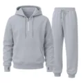 Close up detail of the grey quarter zip hoodie and sweatpants casual sportswear set. - Gray