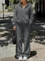 Street style dark gray hoodie and sweatpants detail shot, showing casual wear texture and design. - S / Top And Bottom / Dark Gray