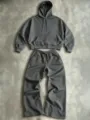 Detail view of dark grey hoodie and wide-leg sweatpants set, cozy texture, casual design. - Gray