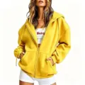 Detail close up of women fleece zip up hooded sweatshirt in yellow with zipper and pockets. - Yellow