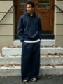 Outdoor detail shot of casual fleece-lined hoodie and wide leg pants tracksuit style. - Navy Blue Set