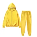 Detail shot of the bright yellow fleece zip-up hoodie and matching casual sweatpants set. - Yellow